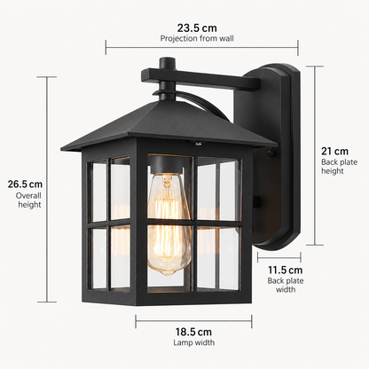 Black outdoor wall sconce with glass panels and an Edison bulb, shown with dimension labels for overall height, lamp width, back plate height, and wall projection on a light gray background.