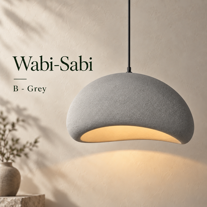 Dome Grey shade option: smooth grey textured resin pendant light with a warm glow against a beige wall