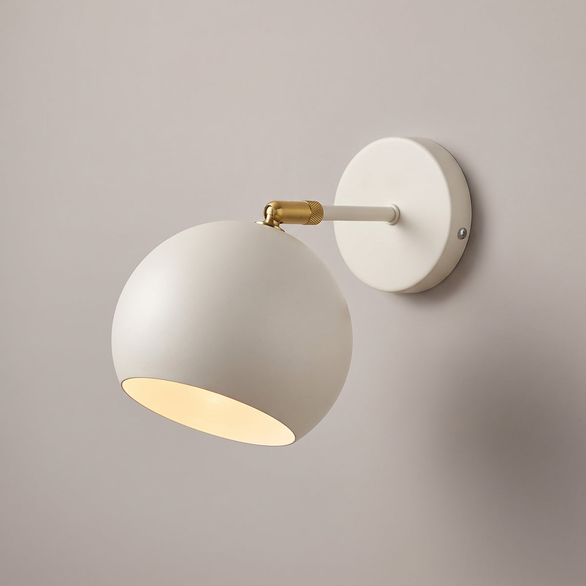 White colour option: adjustable ball wall lamp with matt off-white shade, arm and round wall plate