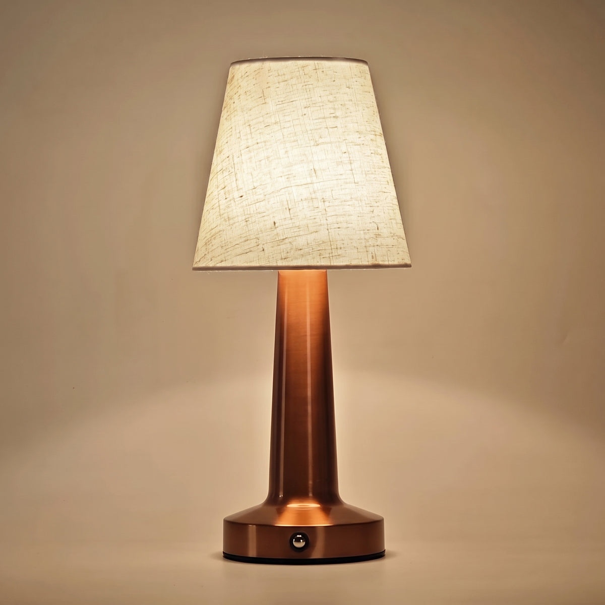 Close-up of the oatmeal linen shade and rose gold column showing the slubbed weave and the button on the base