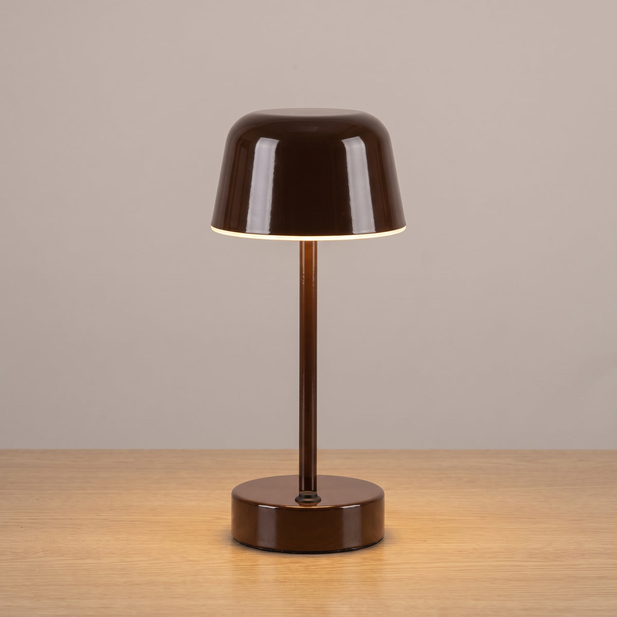 Brown colour option: cordless mushroom table lamp in glossy chocolate brown on a light oak surface