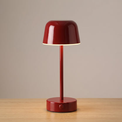 Red colour option: cordless mushroom table lamp in glossy deep red on a light oak surface