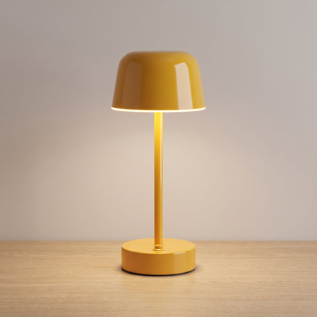 Yellow colour option: cordless mushroom table lamp in glossy warm yellow on a light oak surface