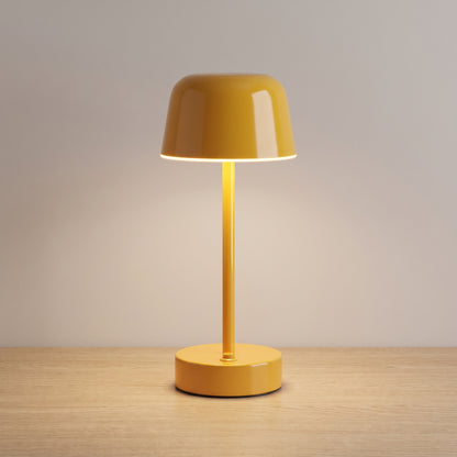 Yellow colour option: cordless mushroom table lamp in glossy warm yellow on a light oak surface