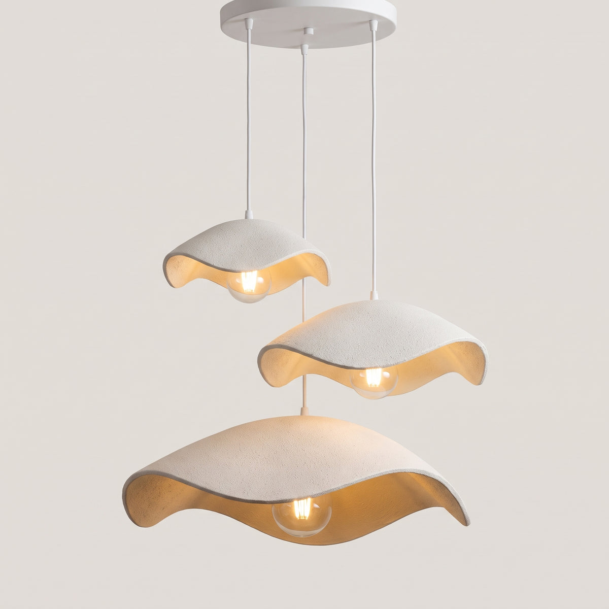 Three-light Shallow Wave version with three white shades on a round ceiling plate