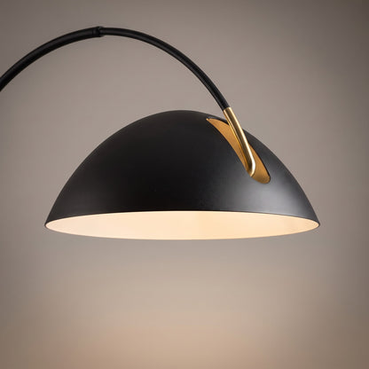 Close up of the matte black metal shade with white interior and brass joint detail