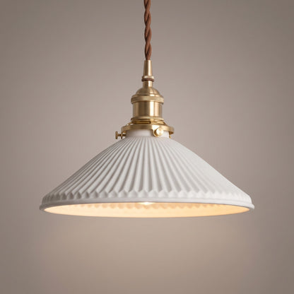 Close up of the fluted white ceramic shade, brass holder and twisted brown cord