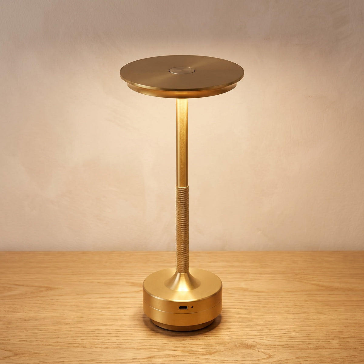 Gold finish option: brushed gold cordless table lamp switched on