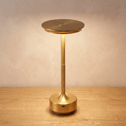 Gold finish option: brushed gold cordless table lamp switched on