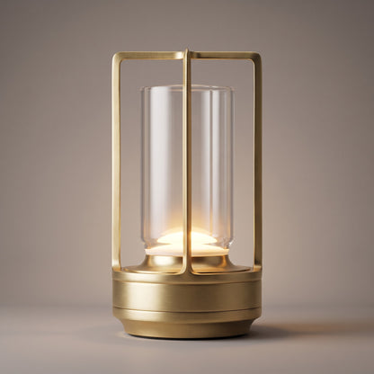 Close up of the gold lantern lamp frame, clear shade and warm LED glow