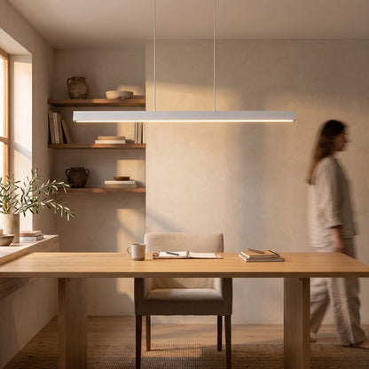 White linear LED pendant above a light oak desk in a home office