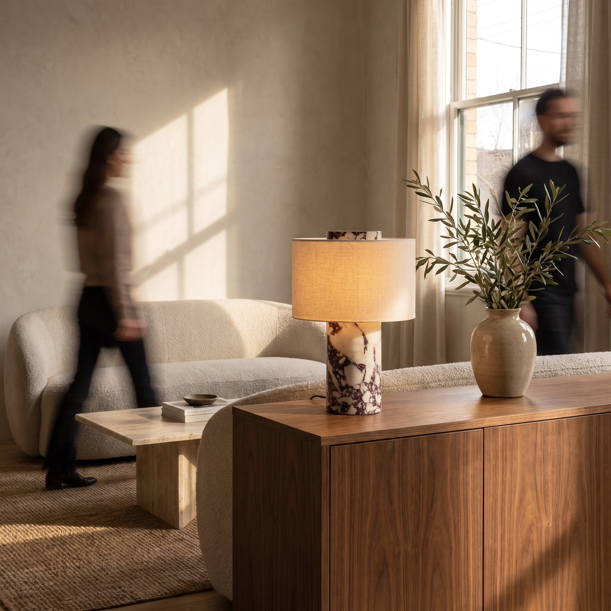 Viola marble table lamp with linen shade on a walnut sideboard in a warm living room