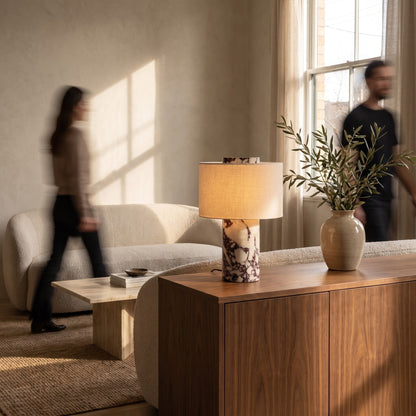 Viola marble table lamp with linen shade on a walnut sideboard in a warm living room