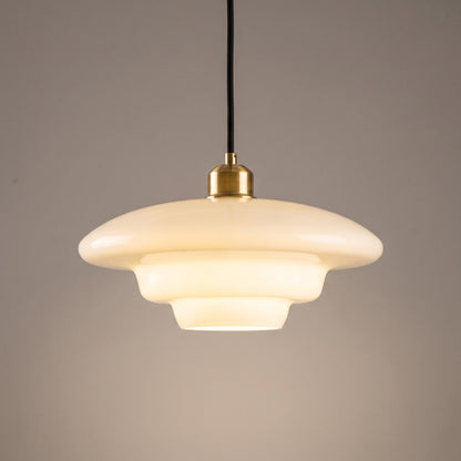 Close up of the opal glass shade, tiered step and polished brass cap